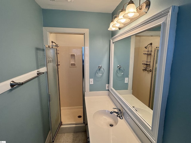 bathroom featuring an enclosed shower, vanity, and tile patterned flooring