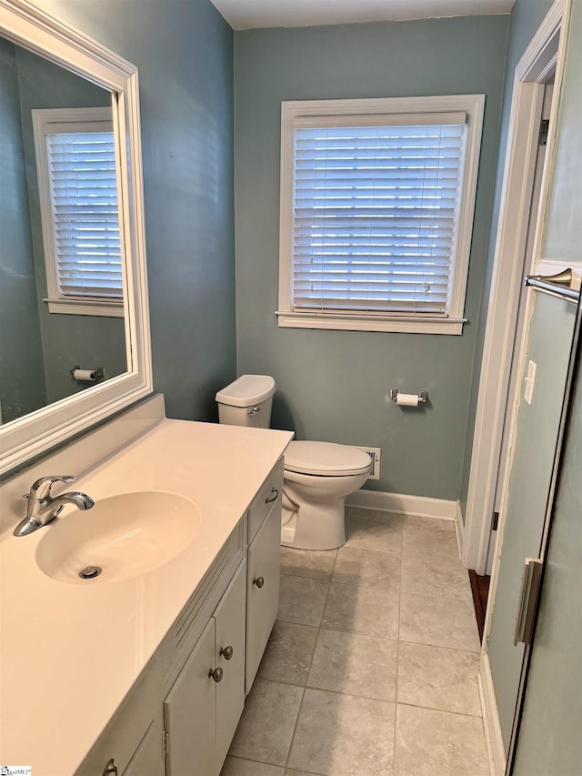 bathroom with vanity, tile patterned floors, and toilet