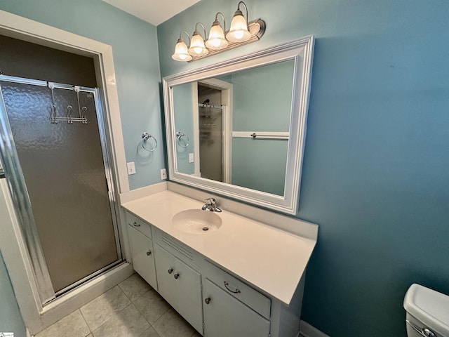 bathroom featuring vanity, a shower with shower door, tile patterned floors, and toilet