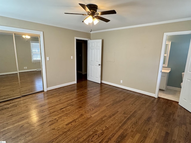 unfurnished bedroom with ornamental molding, dark hardwood / wood-style floors, and a closet