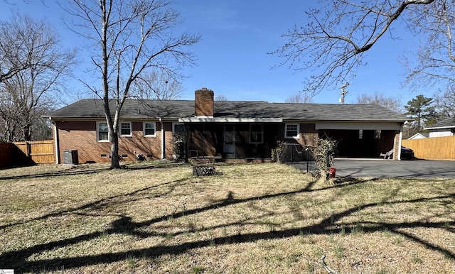 back of house with a carport and a lawn