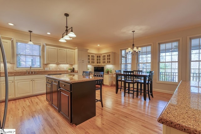 kitchen featuring hanging light fixtures, crown molding, and a center island