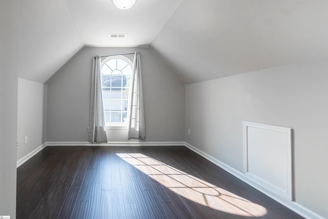 additional living space with lofted ceiling and dark wood-type flooring