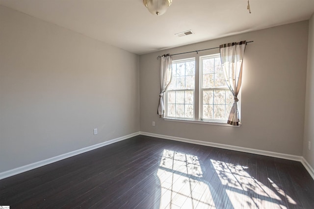 empty room featuring dark hardwood / wood-style flooring