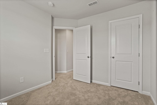 unfurnished bedroom with light colored carpet