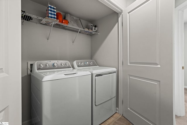 clothes washing area featuring independent washer and dryer