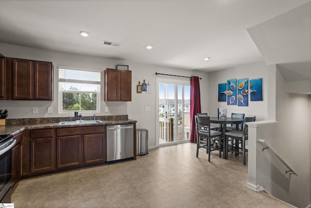 kitchen featuring appliances with stainless steel finishes, sink, and dark brown cabinets