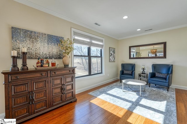 sitting room featuring crown molding and wood-type flooring