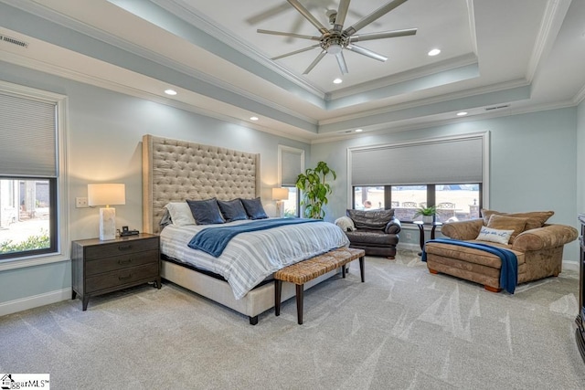 carpeted bedroom featuring crown molding, a tray ceiling, and ceiling fan