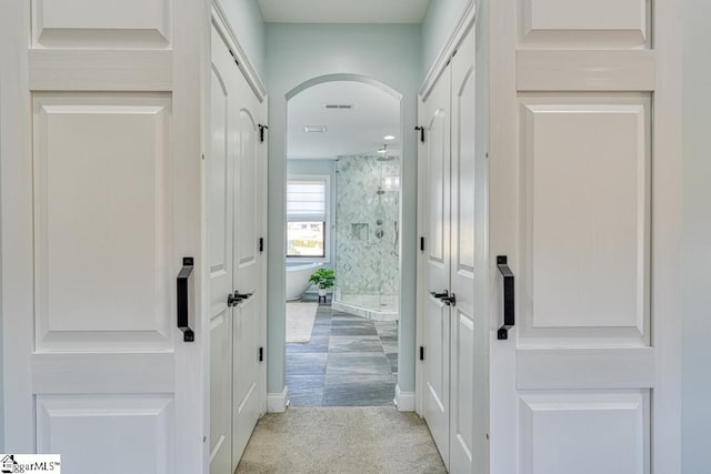 hallway featuring light carpet