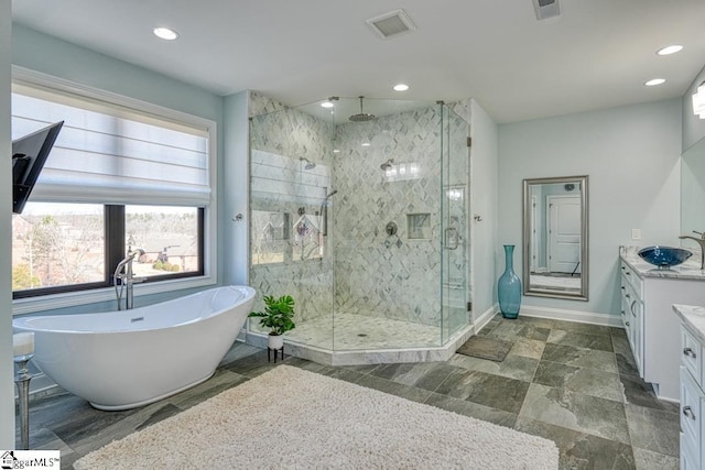 bathroom with vanity and independent shower and bath