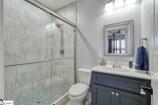 bathroom with vanity, toilet, and a shower with door