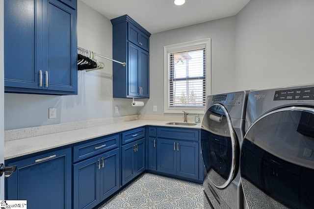 laundry area featuring cabinets, sink, and washing machine and dryer