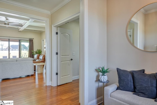 hall with ornamental molding, coffered ceiling, beam ceiling, and light hardwood / wood-style flooring