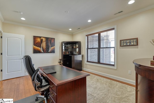 office area featuring crown molding and light hardwood / wood-style flooring