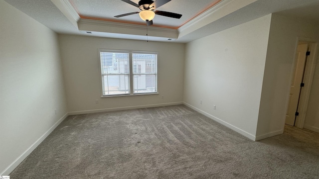 unfurnished room featuring crown molding, a tray ceiling, and carpet floors