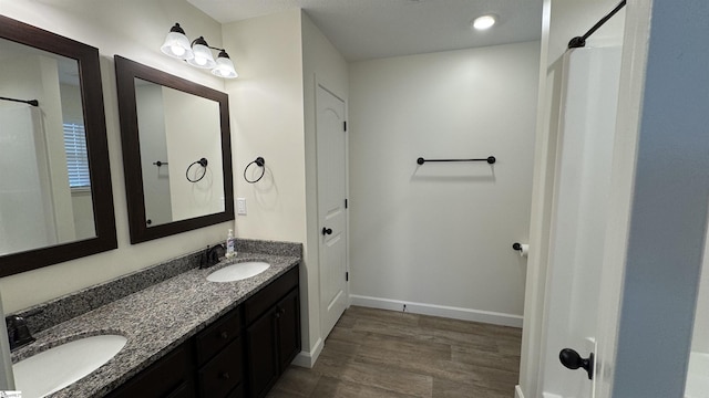 bathroom featuring hardwood / wood-style flooring and vanity