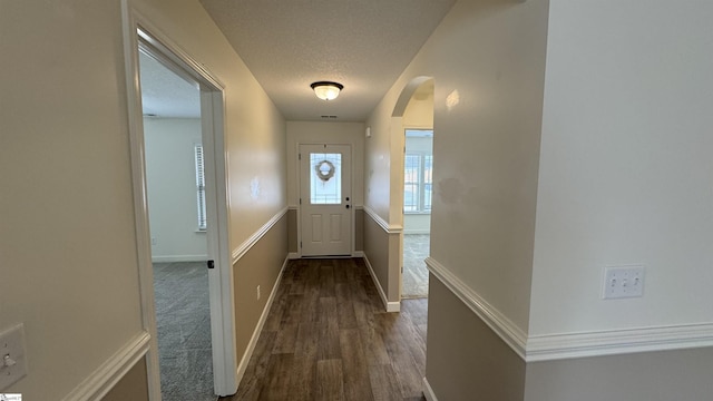 doorway to outside featuring dark hardwood / wood-style floors and a textured ceiling