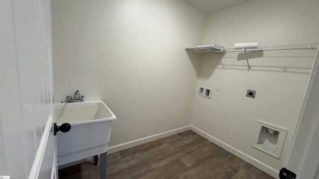 laundry area with dark wood-type flooring, washer hookup, and hookup for an electric dryer