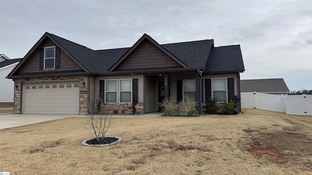 craftsman house with a garage and a front lawn