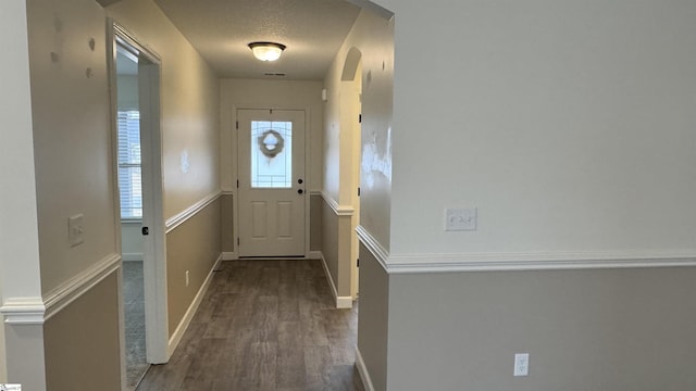 entryway featuring dark hardwood / wood-style floors and a textured ceiling