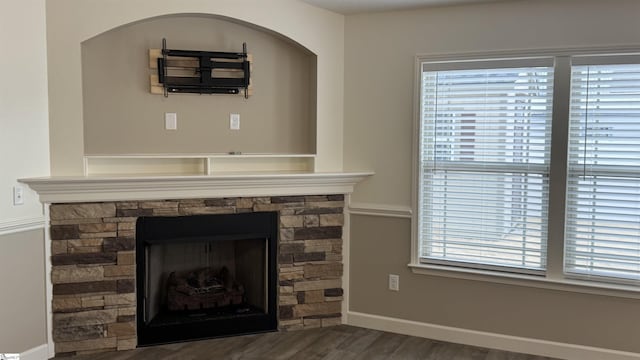 interior details with a stone fireplace and hardwood / wood-style floors