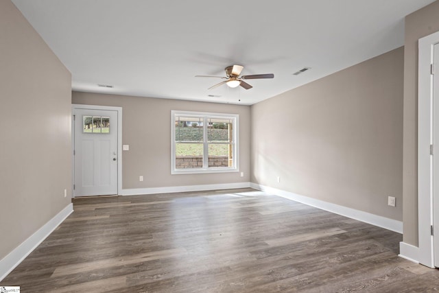 interior space with dark wood-type flooring and ceiling fan