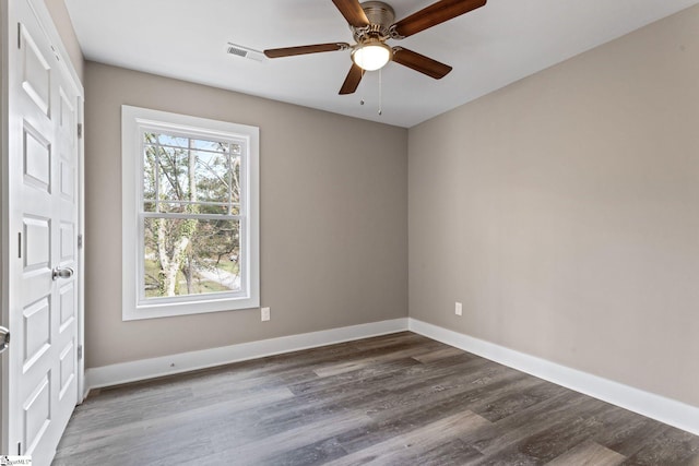 spare room with hardwood / wood-style flooring and ceiling fan