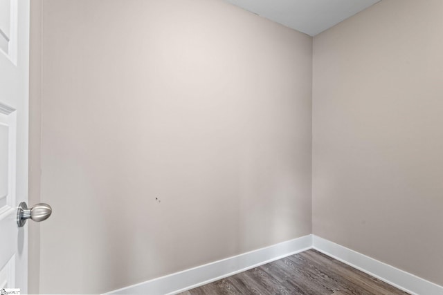 unfurnished room featuring dark wood-type flooring