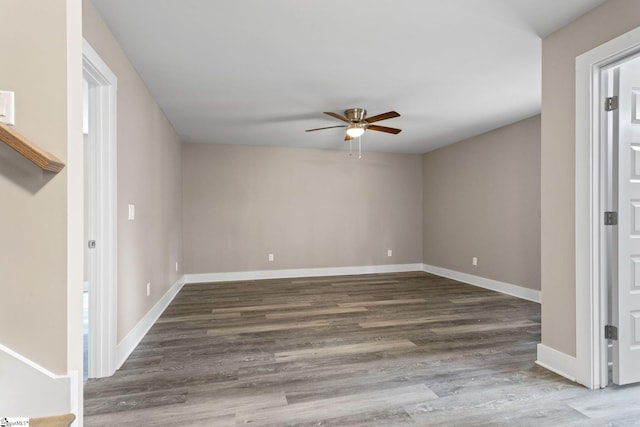 unfurnished room with dark hardwood / wood-style floors and ceiling fan