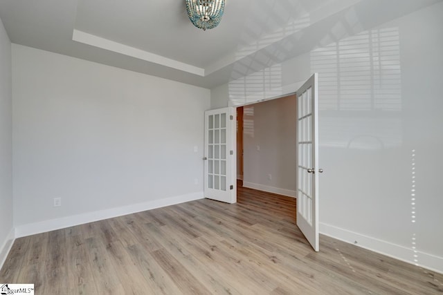 spare room with french doors and light wood-type flooring