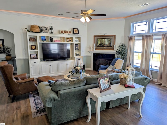 living room featuring crown molding, dark hardwood / wood-style floors, and ceiling fan