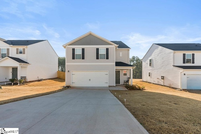 view of property featuring a garage and a front lawn