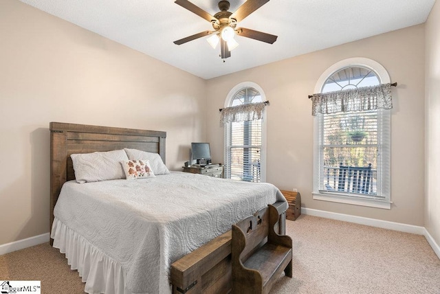 bedroom featuring ceiling fan and light carpet