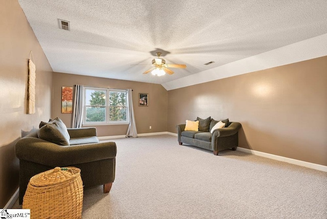 living room with vaulted ceiling, light colored carpet, a textured ceiling, and ceiling fan