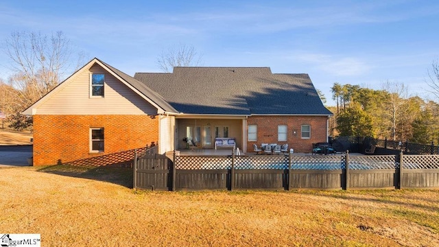 rear view of house with a yard