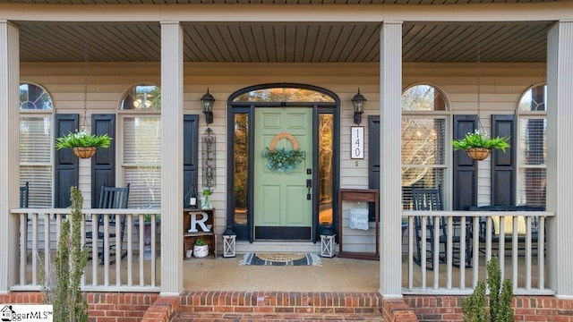 property entrance with covered porch