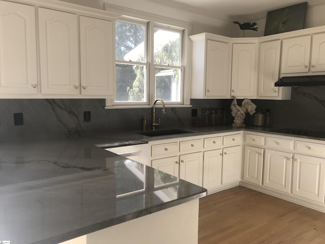 kitchen with sink, white cabinetry, backsplash, black electric stovetop, and dark hardwood / wood-style flooring