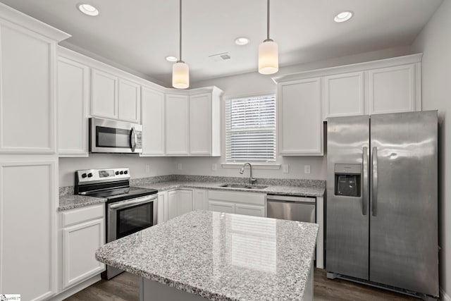 kitchen featuring pendant lighting, sink, white cabinets, and appliances with stainless steel finishes