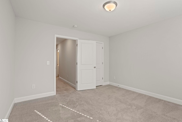 unfurnished bedroom featuring light carpet