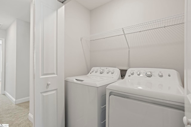 laundry area with light carpet and washer and clothes dryer