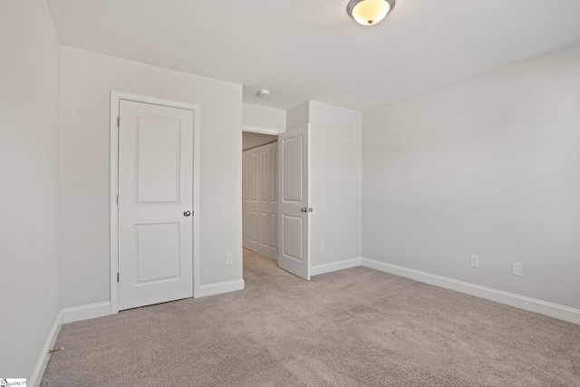 unfurnished bedroom featuring light colored carpet