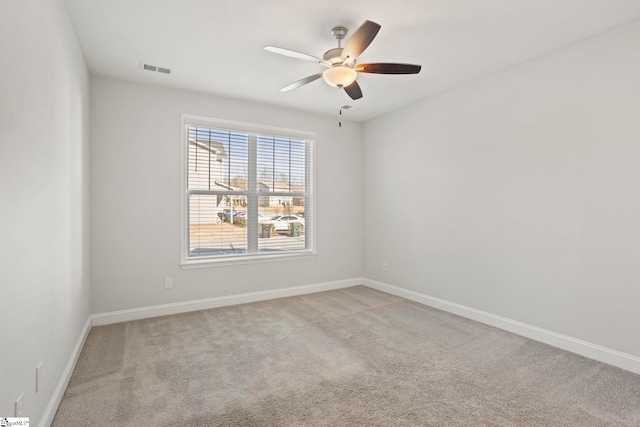 carpeted spare room featuring ceiling fan