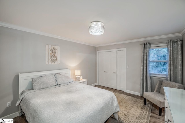 bedroom featuring ornamental molding, a closet, and light hardwood / wood-style flooring