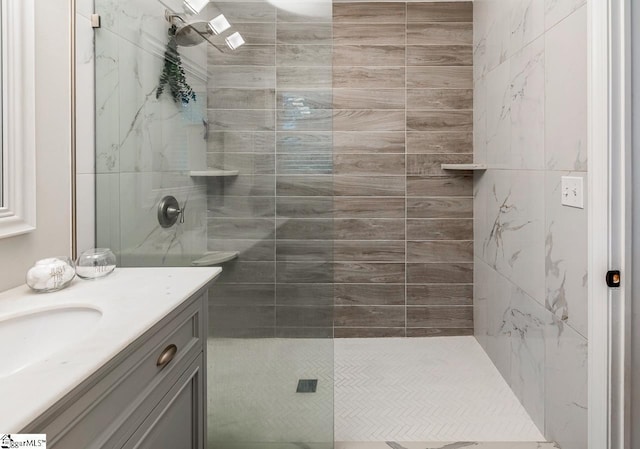 bathroom featuring vanity and a tile shower