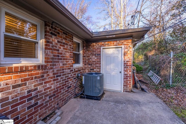 property entrance featuring cooling unit and a patio area