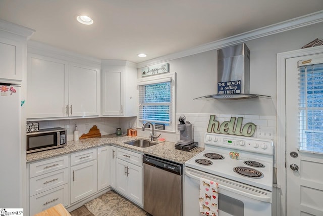 kitchen with sink, white cabinetry, stainless steel appliances, light stone counters, and wall chimney exhaust hood