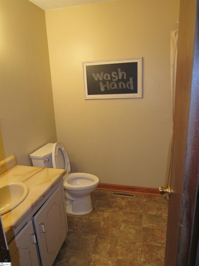 bathroom with vanity and toilet