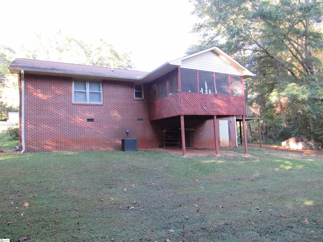 rear view of property featuring central AC, a yard, and a sunroom