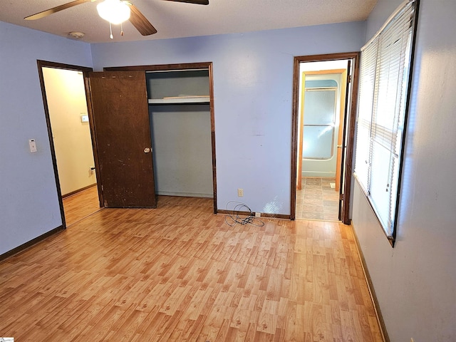 unfurnished bedroom featuring a closet, ceiling fan, and light wood-type flooring